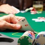 Man playing pokerMan checking his cards during poker game ID 4